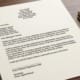 a resignation letter on a polished timber desk with pen