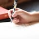 Hand writing a letter on paper