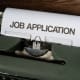 Typewriter with job application paper