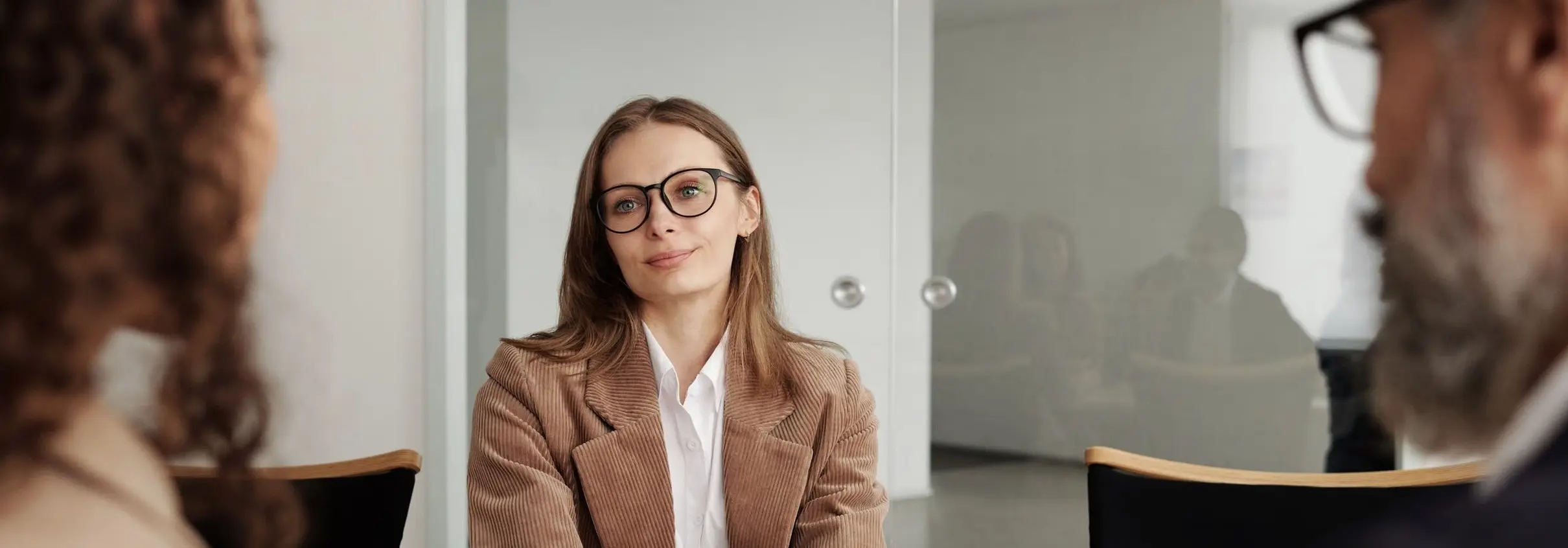 Executive interview candidate holding the attention of a two-person senior panel